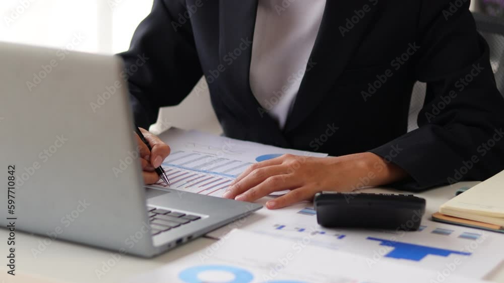Close up businesswoman working with laptop and paperwork, Analyzing financial accounts and planning business project budgets. Close up businesswoman working with laptop and paperwork, Analyzing financial accounts and planning business project budgets.