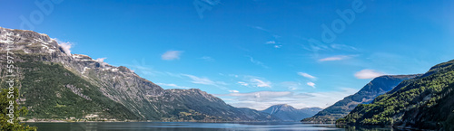 The wide panorama of the lake in Norway with the mountains in the background. 
