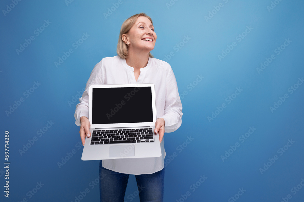 portrait of happy mature business woman with blond hair with laptop with screen template portrait of happy mature business woman with blond hair with laptop with screen template