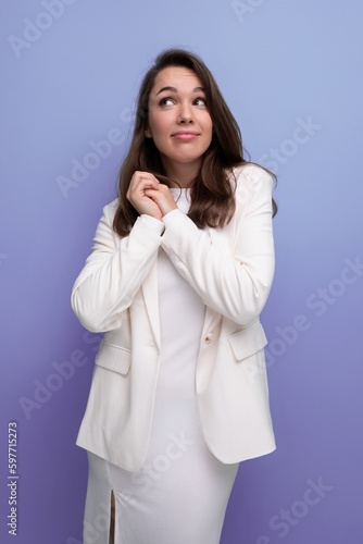 portrait of a well-groomed caucasian brunette woman in a white dress © Ivan Traimak