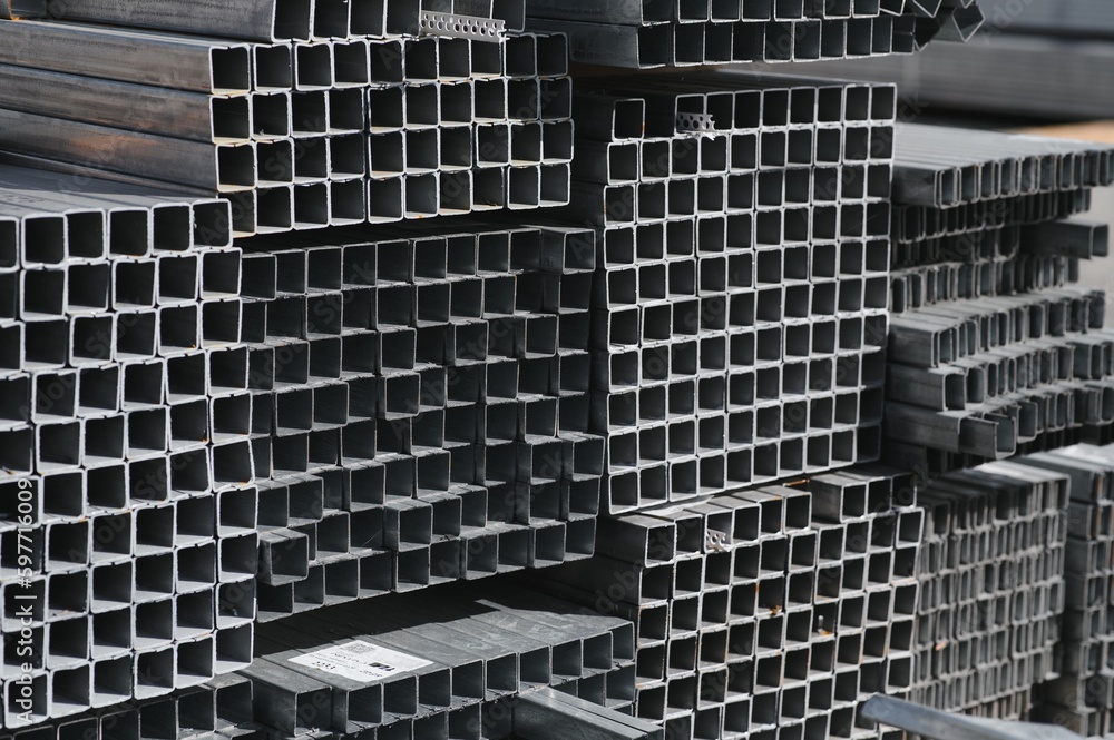 Obraz premium Stack of rolled metal products, perspective view of steel pipes of rectangular cross-section