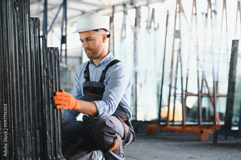Factory for aluminum and PVC windows and doors production. Manual worker assembling PVC windows and doors. Factory for aluminum and PVC windows and doors production. Manual worker assembling PVC windows and doors.