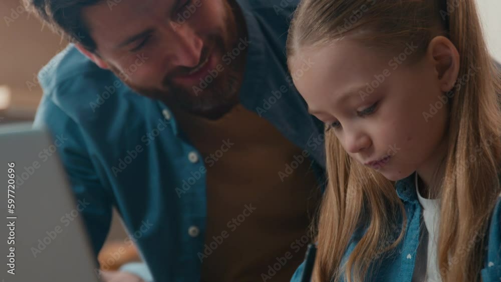 Caucasian happy family studying at home. Father help little daughter with homework study online laptop class lesson distant learning e-learning dad teaching school child girl at kitchen quarantine Caucasian happy family studying at home. Father help little daughter with homework study online laptop class lesson distant learning e-learning dad teaching school child girl at kitchen quarantine