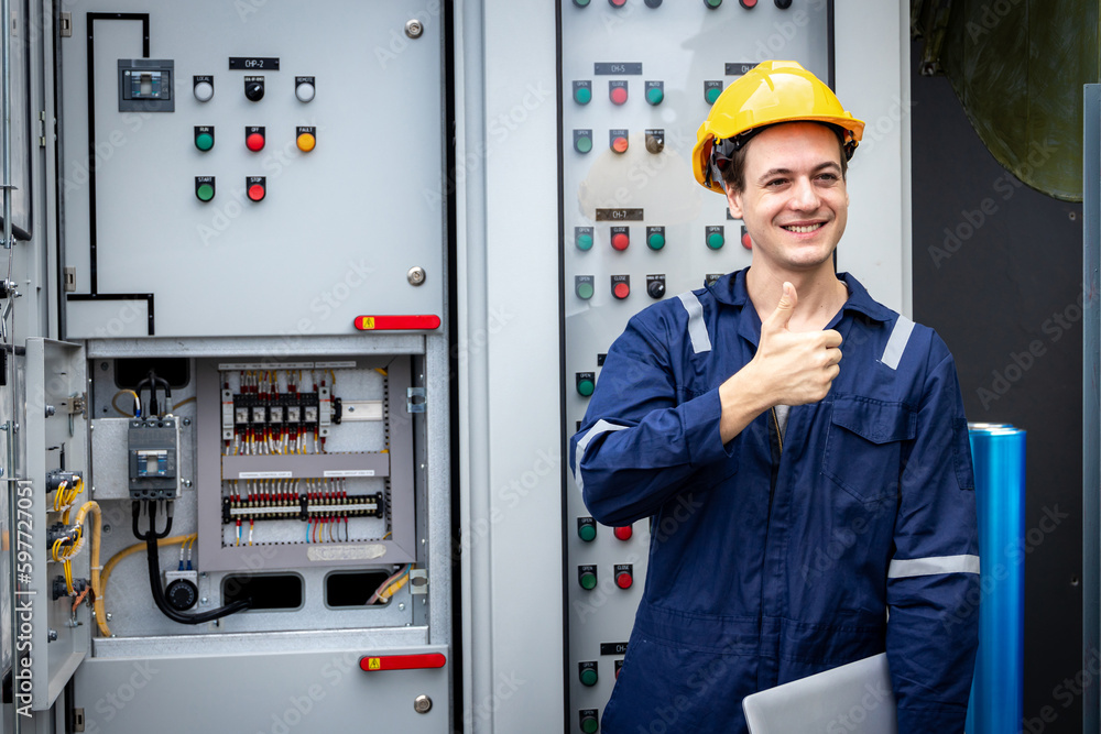 Electrical engineer working in control room. Electrical engineer man checking Power Distribution Cabinet in the control room
