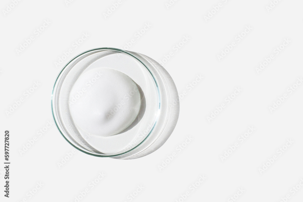 Foam, foam texture. Washing with foam. Foam in a Petri dish on a light background. Dab of cosmetic foam. Lab. Foam, foam texture. Washing with foam. Foam in a Petri dish on a light background. Dab of cosmetic foam. Lab.