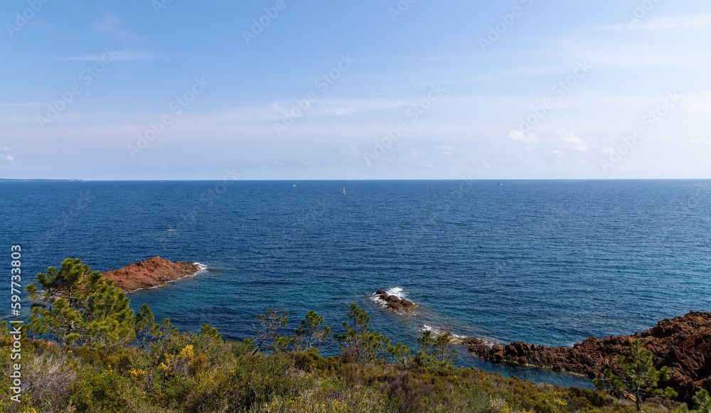 Steep coast on the Cote d'Azur, French Riviera, overlooking the open Mediterranean Sea with ships
