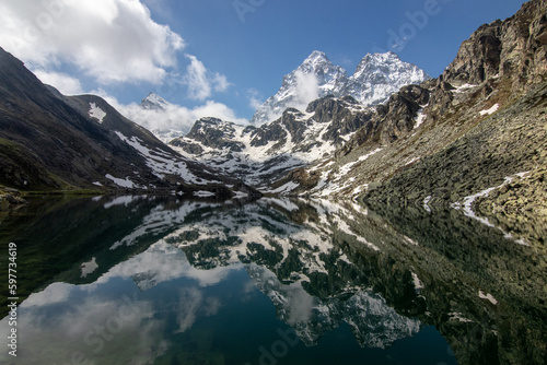 il monviso ancora innevato si specchia nelle acque del lago fiorenza photo