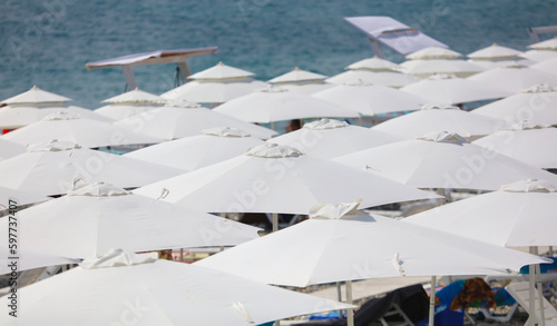 White umbrellas on the beach as a background
