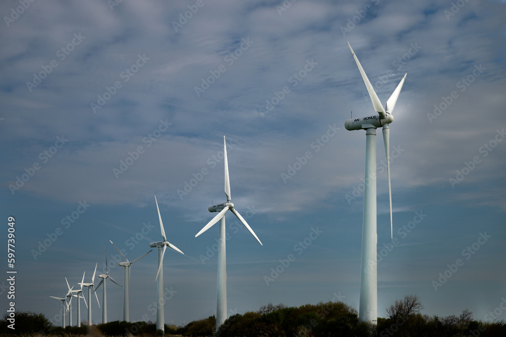Wind turbines in the evening sun on the North Sea dike near Dorum-Neufeld, Lower Saxony, Germany Wind turbines in the evening sun on the North Sea dike near Dorum-Neufeld, Lower Saxony, Germany