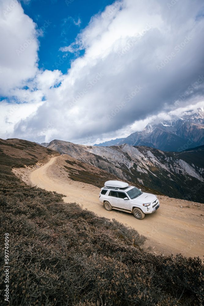 Driving car on high altitude mountain trail, China