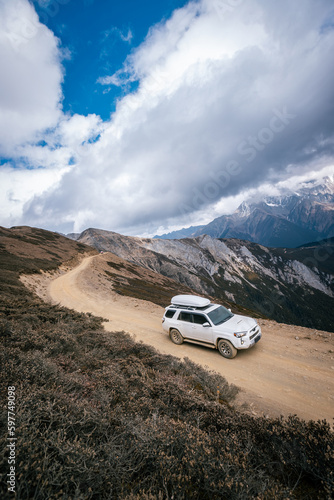 Driving car on high altitude mountain trail, China © lzf