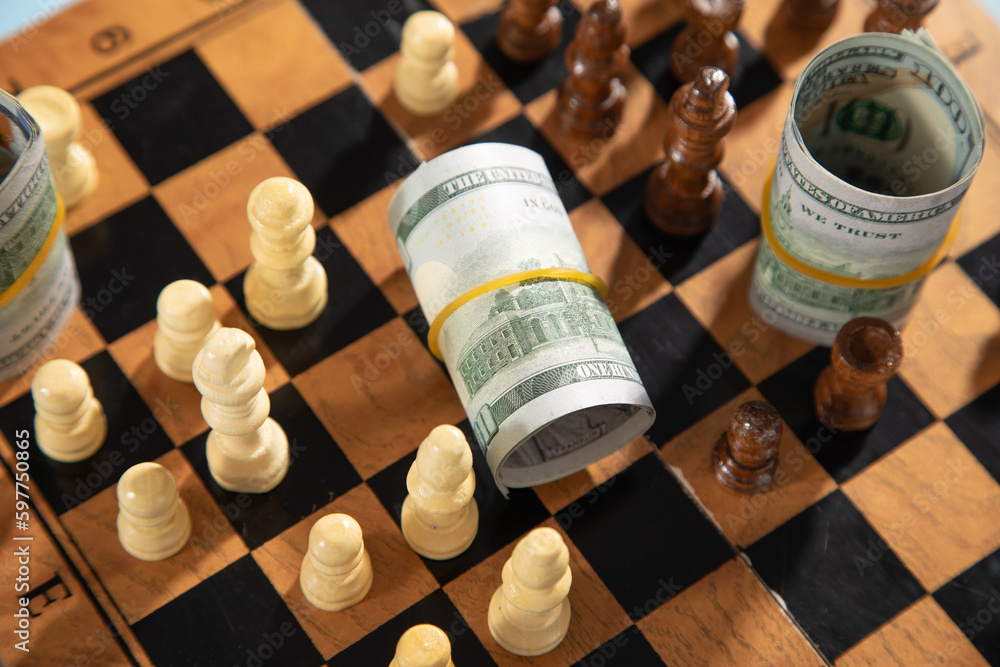 Chess figures and dollar money on the chessboard. Chess figures and dollar money on the chessboard.