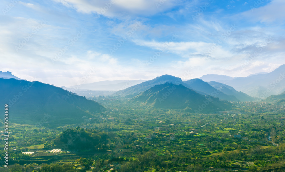 landscape of green summer highland mountain range with green beautiful valley below and amazing blue cloudy sky landscape of green summer highland mountain range with green beautiful valley below and amazing blue cloudy sky