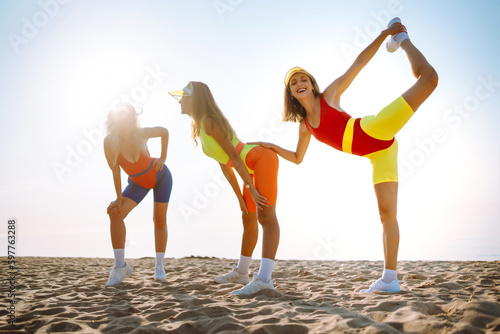 Young dancers in colorful swimsuits are dancing in the morning. Сoncept of sports, fitness, aerobics. Active sport.