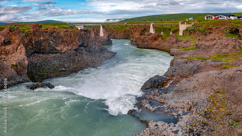 Wonderful and high Icelandic Godafoss waterfall , it is river and a bridge, Iceland, summer Wonderful and high Icelandic Godafoss waterfall , it is river and a bridge, Iceland, summer