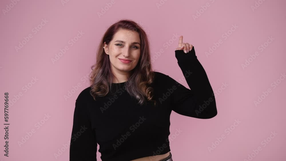 4k video of girl with cunning facial expression on pink background. 4k video of girl with cunning facial expression on pink background.