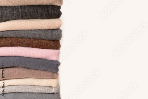 Closeup Stack of folded different colorful knitted on white background