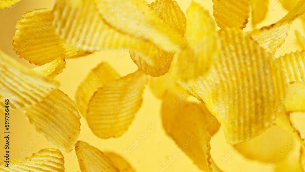 Potatoes chips flying up in the air. Potatoes chips flying up in the air.