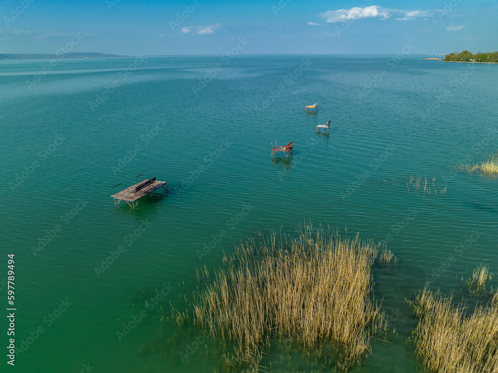 Hungary - Lake Balaton beach textures with boats with reeds and piers from drone view