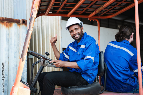 Portrait of a man working with a forklift in a warehouse. Concept industrial and commercial. photo