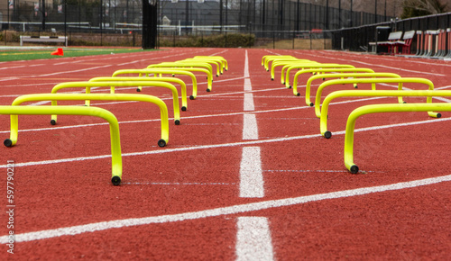 Close up view of small yellow hurdles in two lanes on a track