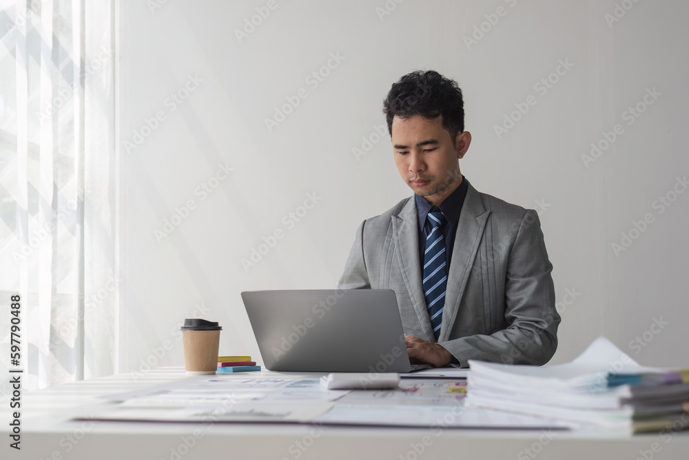 Businessman using calculator for do math finance on wooden desk in office and business working background, tax, accounting, statistics and analytic research concept.. Businessman using calculator for do math finance on wooden desk in office and business working background, tax, accounting, statistics and analytic research concept..