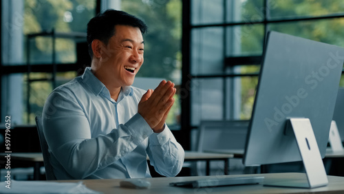 Senior happy emotional businessman male winner investor 40s asian korean man celebrate business success career growth win commercial bet profit successful advancement rejoice feel excitement victory