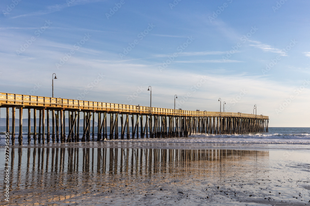 A view on the pier on the Pacific coast at sunset