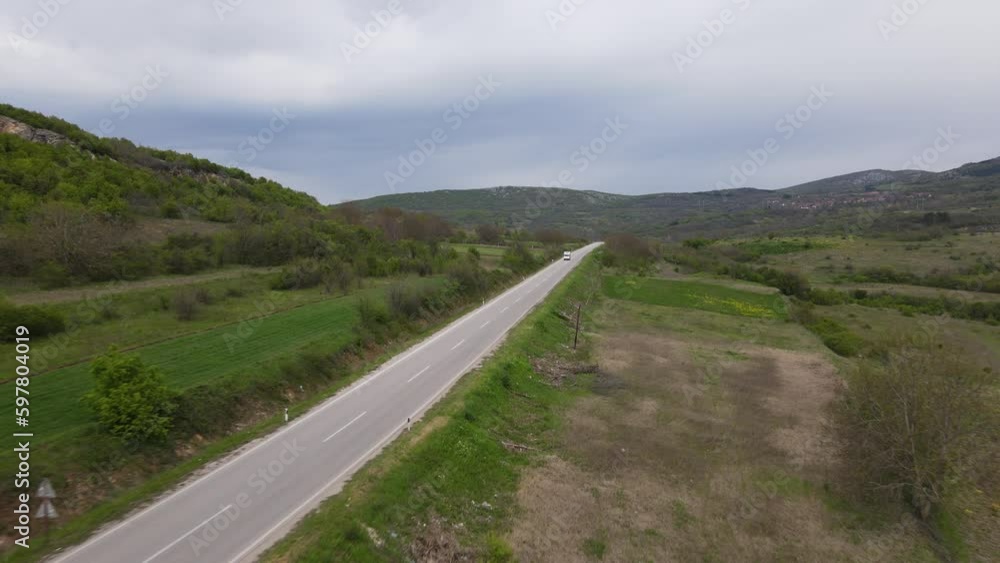 aerial view drone view on truck drive on the road trough the agricultural field near village in spring day in Serbia transport concept aerial view drone view on truck drive on the road trough the agricultural field near village in spring day in Serbia transport concept
