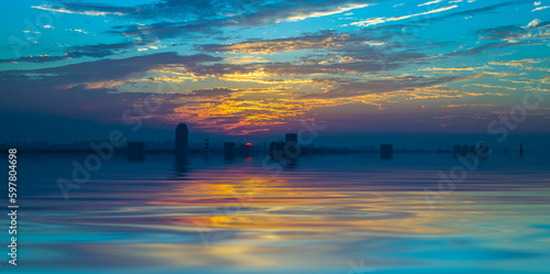 Soft dreamlike reflections of colorful sky and water ripples