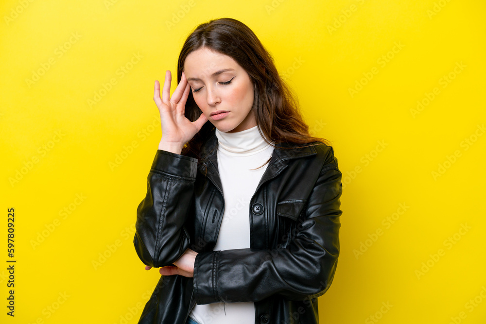 Young caucasian woman isolated on yellow background with headache Young caucasian woman isolated on yellow background with headache