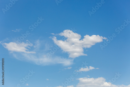 Beautiful white puffy clouds in a blue sky. A pretty cloudscape. Fresh, airy light and clean. Clouds above the Sonoran Desert in Tucson, Arizona, USA. © Charles