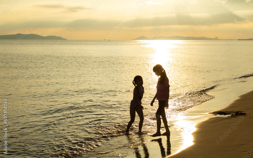 silhouette couple in love on summer beach sunset. Happy romantic couple enjoying and relaxing on the Beach