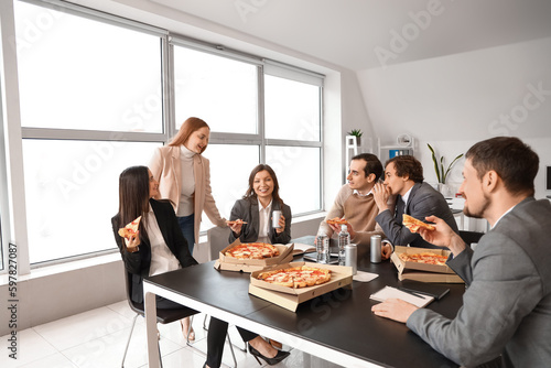 Group of business people with tasty pizza in office