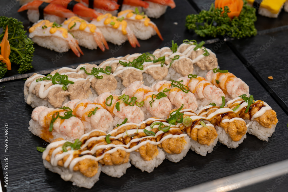 different kind of sushis on a tray. sushi buffet.