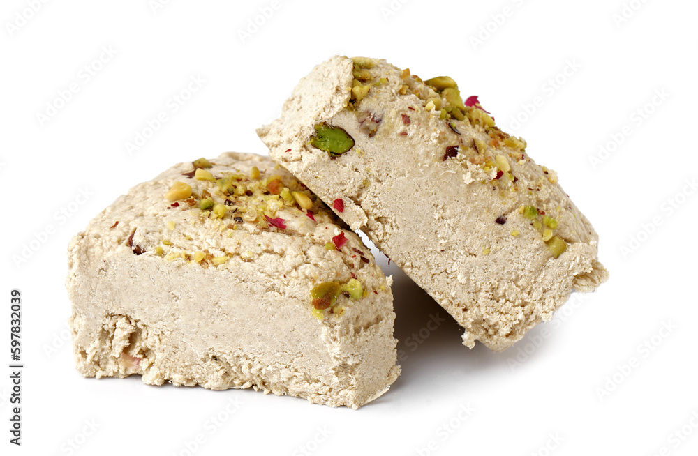 Pieces of tasty Tahini halva with pistachios on white background