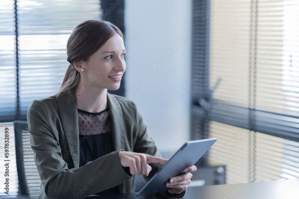 Happy young businesswoman American siting on the chair cheerful demeanor raise holding coffee cup smiling looking laptop screen.Making opportunities female working successful in the office. Happy young businesswoman American siting on the chair cheerful demeanor raise holding coffee cup smiling looking laptop screen.Making opportunities female working successful in the office.