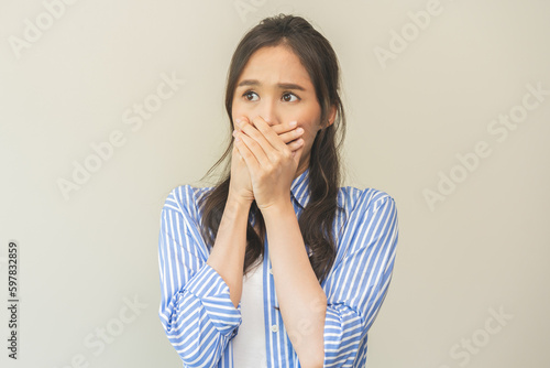 Portrait of pretty brunette hair, disgust smell bad breath strong asian young woman shocked covering, close her mouth with hand, expression face disgusting, dislike odor. Isolated on white background.