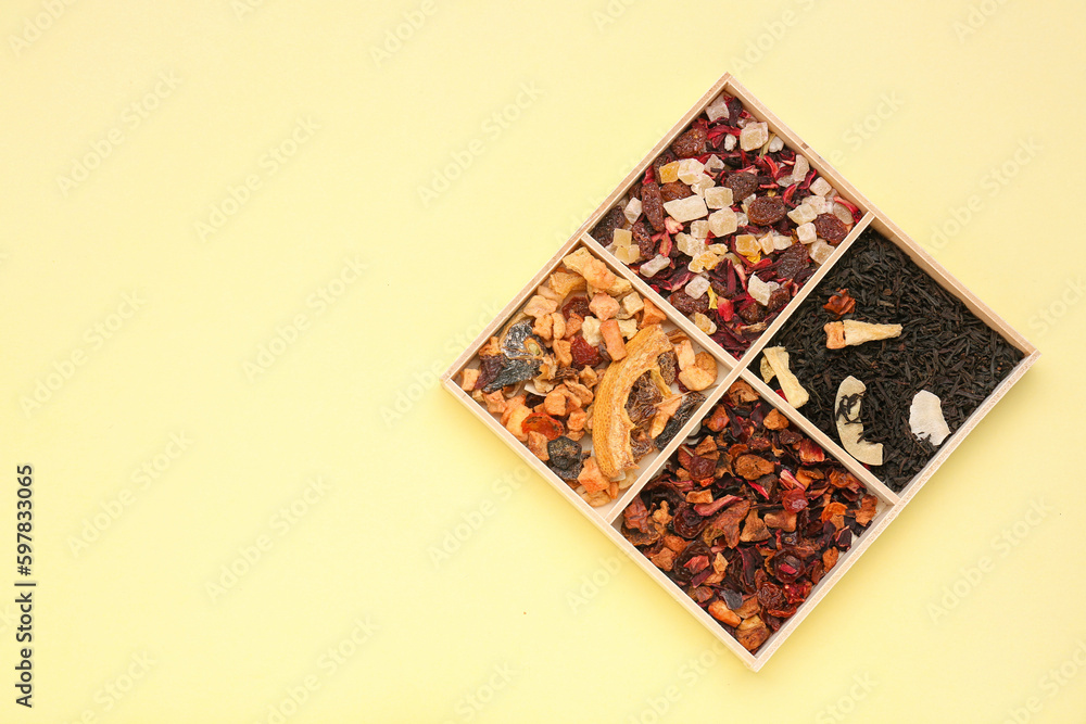 Board with different dried fruit tea on yellow background Board with different dried fruit tea on yellow background