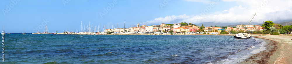 panoramic view of the beach, the marina and the famous seaside resort of Saint Florent, capital of the Nebbio region of the island of Corsica, nicknamed the Island of Beauty