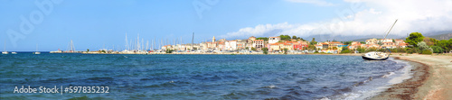 panoramic view of the beach, the marina and the famous seaside resort of Saint Florent, capital of the Nebbio region of the island of Corsica, nicknamed the Island of Beauty photo
