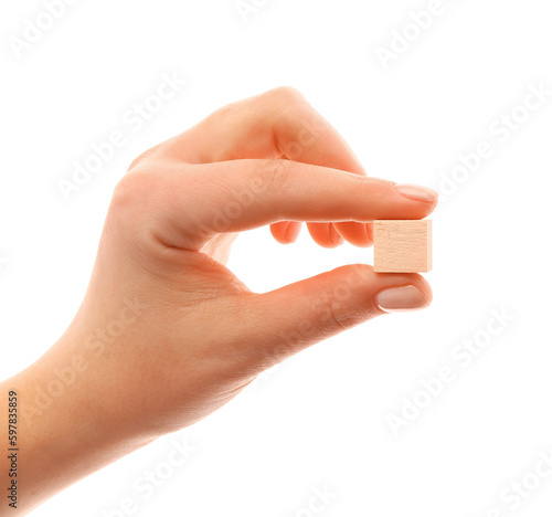 Female hand with wooden cube isolated on white background, closeup