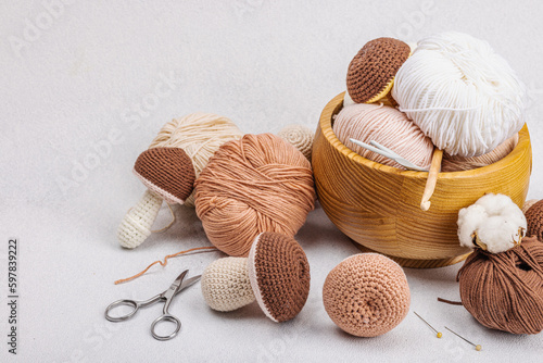 Set of clew of thread for knitting. Crocheted mushrooms, handmade, hobby concept. Props