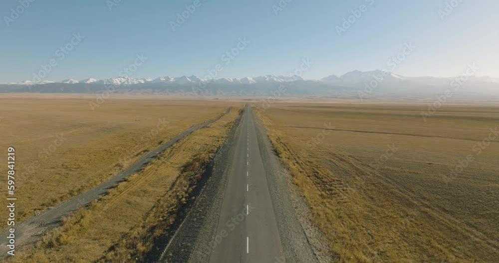 Empty endless road asphalt straight freeway through arid flat steppe with mountains backgorund. Aerial top down view, Highway trip without cars at summer sunny day
Empty endless road asphalt straight freeway through arid flat steppe with mountains backgorund. Aerial top down view, Highway trip without cars at summer sunny day