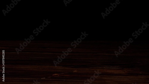 sliding a whisky glass on a counter top -black background (4k - slow motion)[ high quality colors]