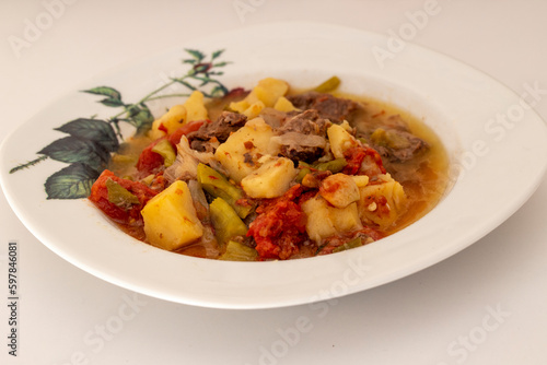 Meat stew with potatoes in a white plate