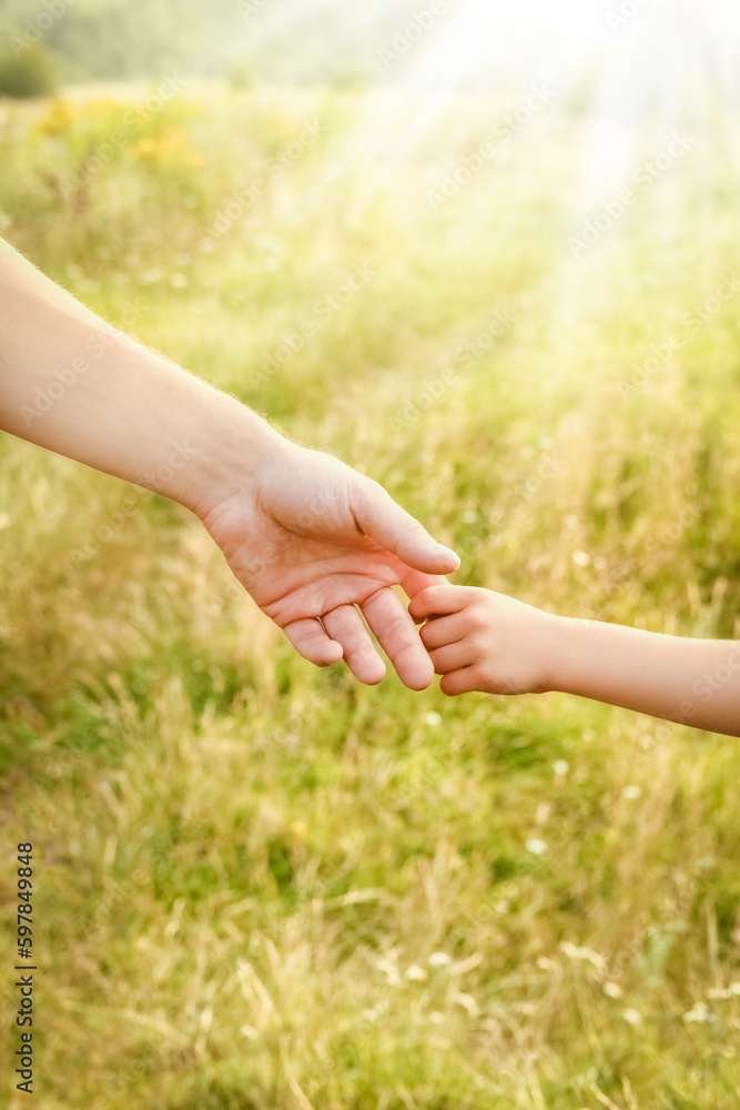 hands of parent and child in nature hands of parent and child in nature