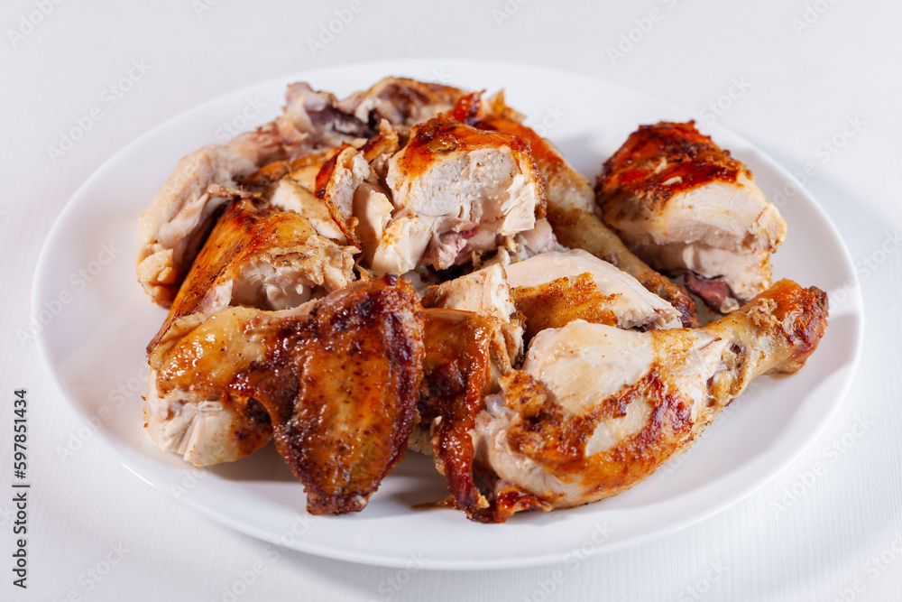 Sliced fried chicken on a white plate Sliced fried chicken on a white plate