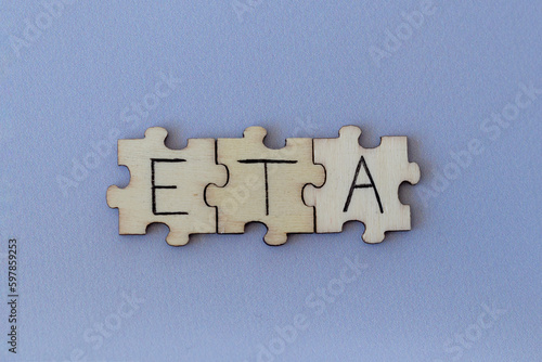 The acronym ETA, which stands for Estimated Time of Arrival. The letters written on the puzzles.