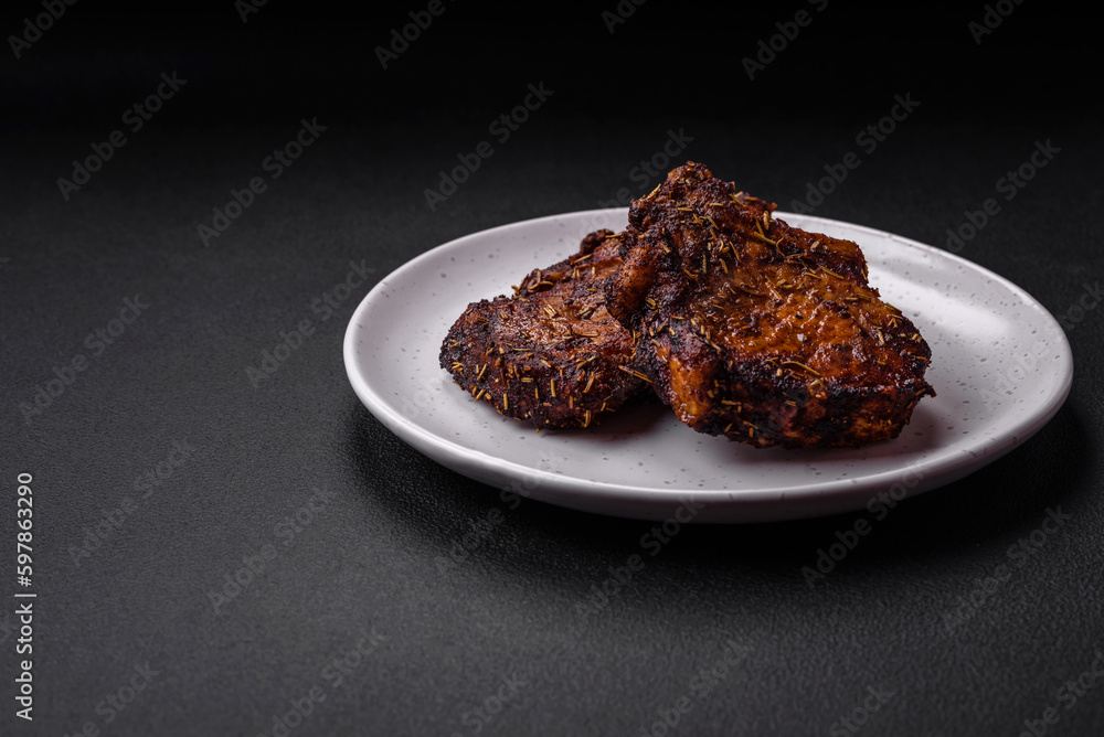 Delicious beef or pork steak on the bone grilled with spices and rosemary Delicious beef or pork steak on the bone grilled with spices and rosemary